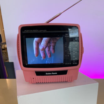 "release" - video loop on small pink TV